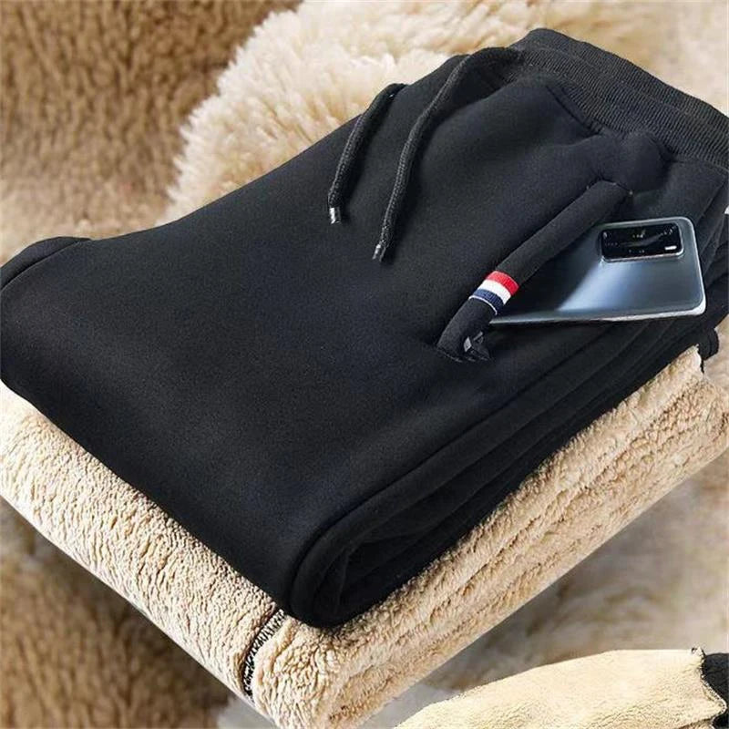 Jogging noir en coton doublé polaire, plié, poche zippée