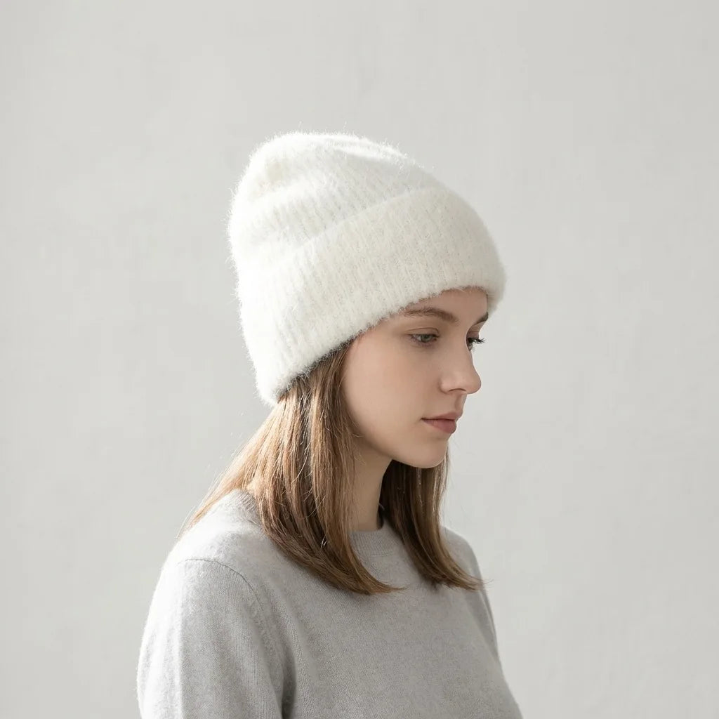 Modèle portant un bonnet blanc en alpaga et un chandail gris clair