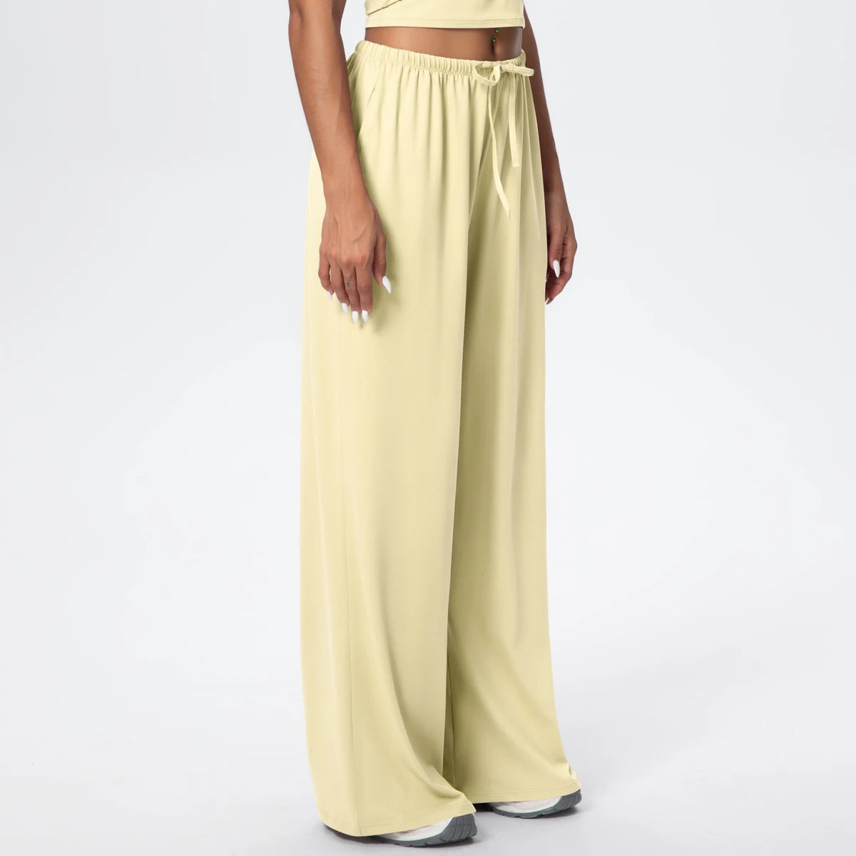 Pantalon de yoga taille haute jaune clair, jambe large, porté, vue de trois quarts