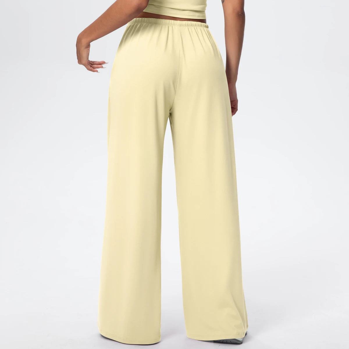 Pantalon de yoga taille haute jaune clair, jambe large, porté, vue de dos